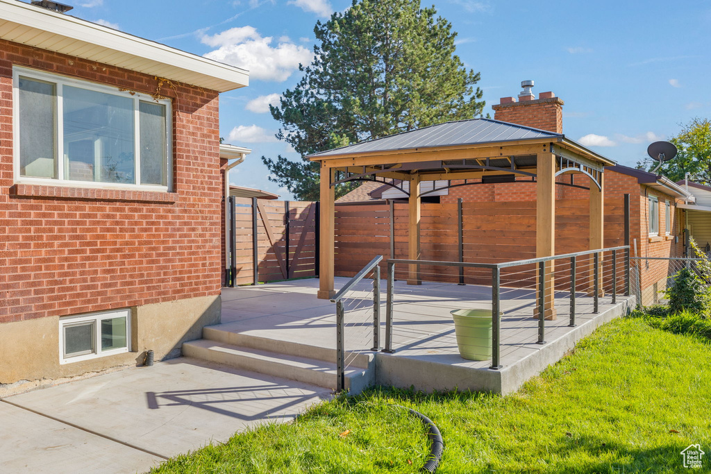 Exterior space featuring a gazebo, a patio, and a lawn