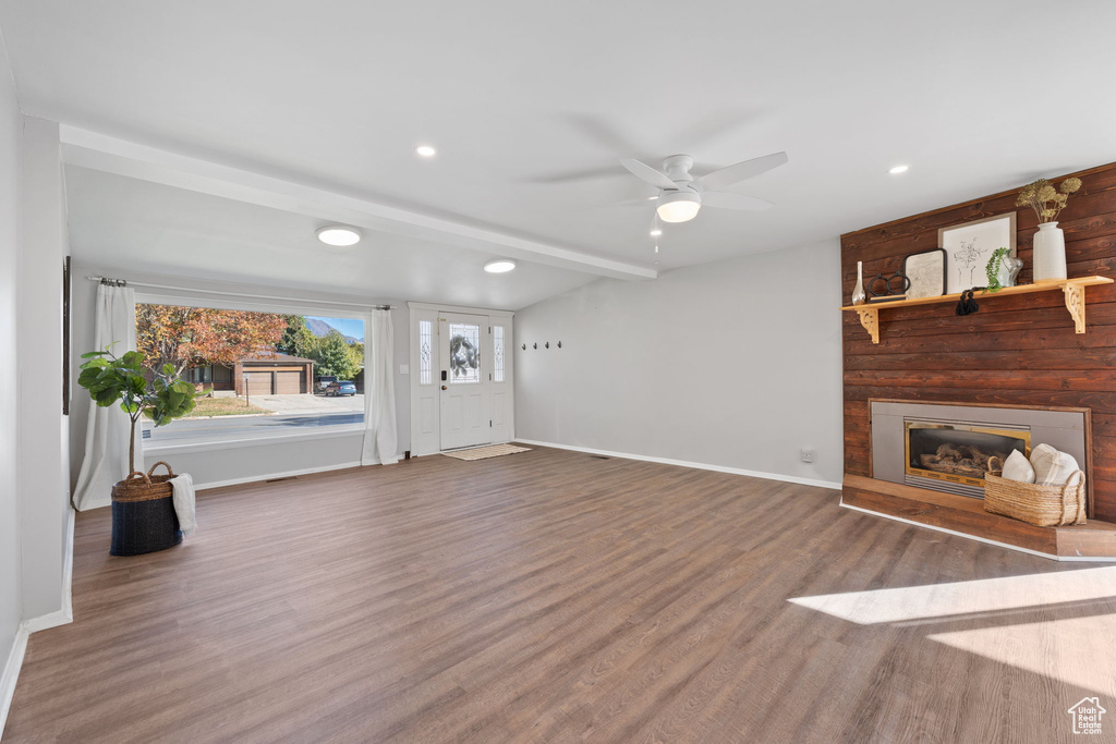 Unfurnished living room featuring ceiling fan and hardwood / wood-style floors