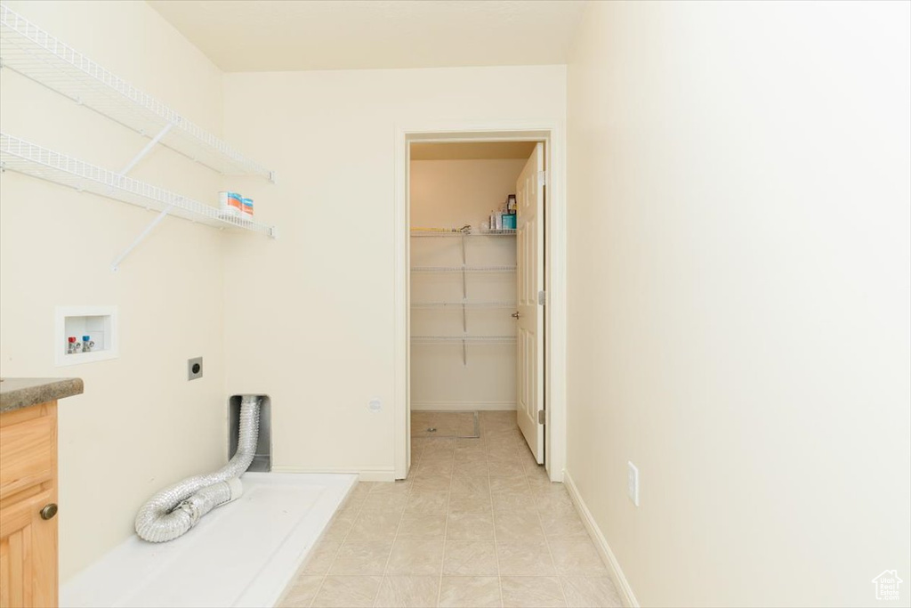 Laundry area featuring electric dryer hookup, washer hookup, and baseboards