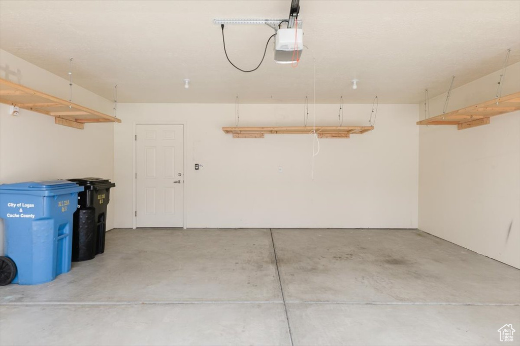 Garage featuring a garage door opener