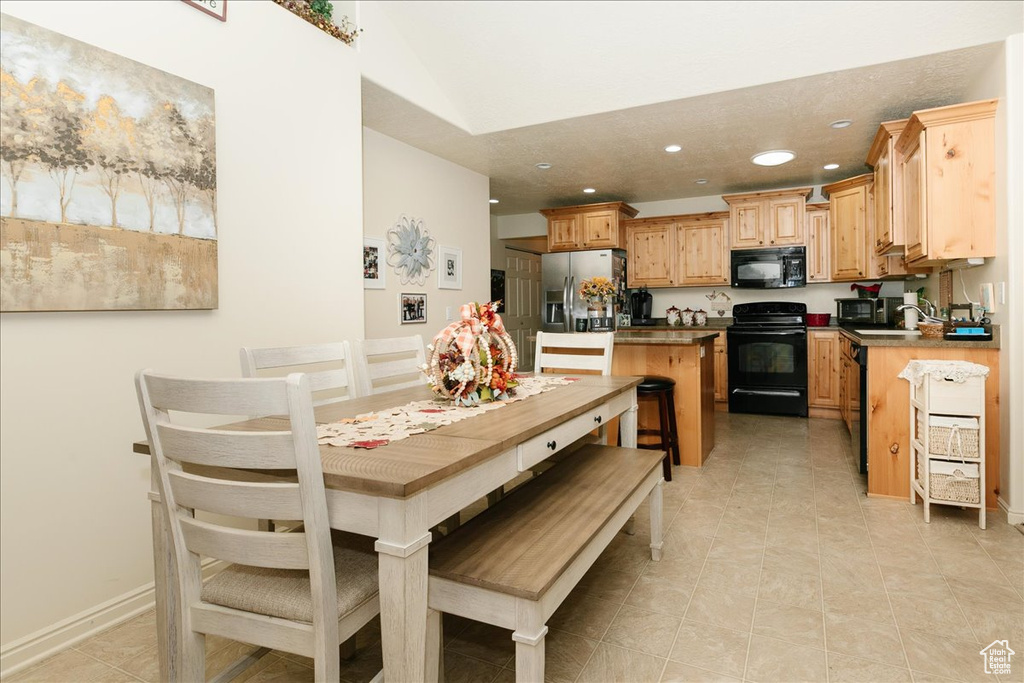 Dining room featuring light tile patterned flooring and sink