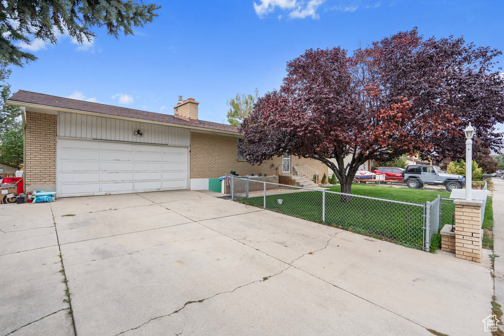 Single story home with a front lawn and a garage