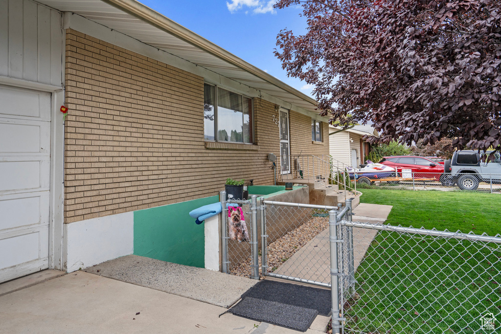 View of property exterior with a yard