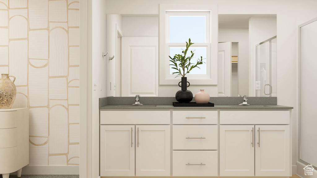 Bathroom featuring vanity and a shower with door