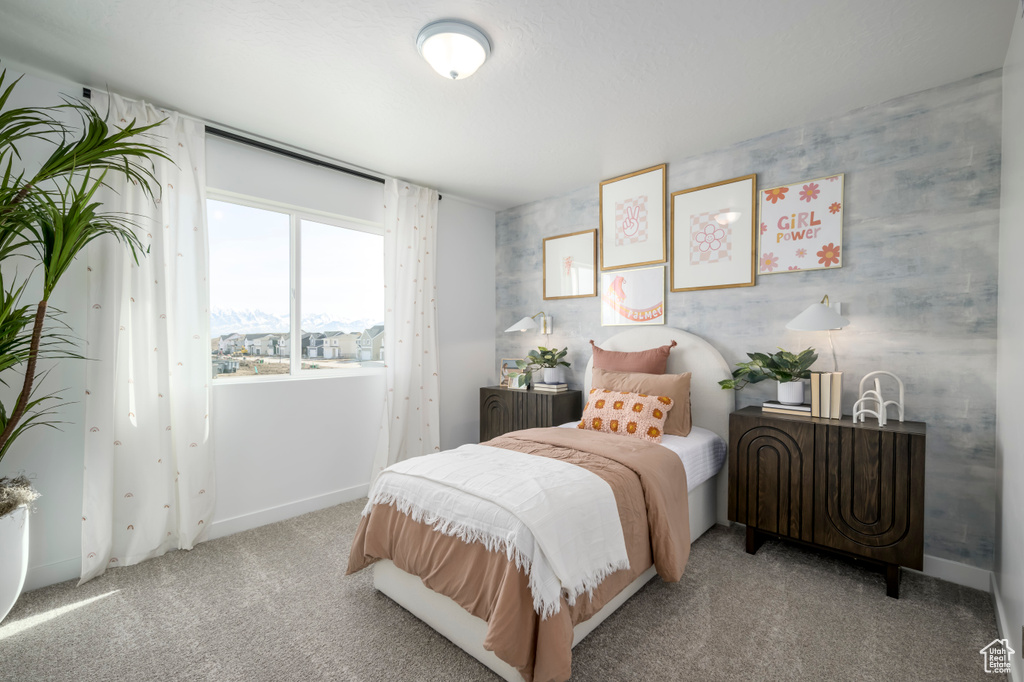 Bedroom featuring light carpet