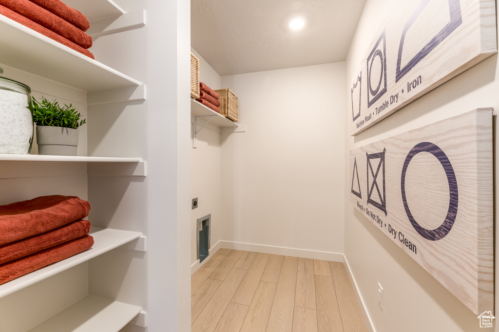 Interior space with hardwood / wood-style floors and electric dryer hookup