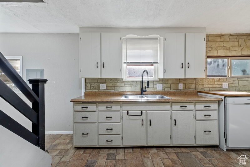 Kitchen with dishwasher, a healthy amount of sunlight, and sink