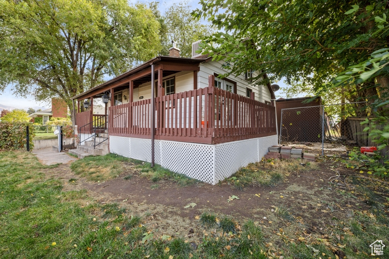 Back of house with a deck