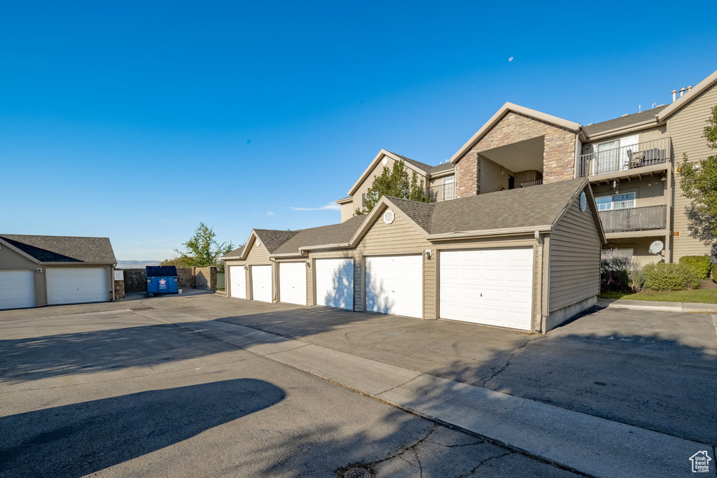 Exterior space with a balcony and a garage