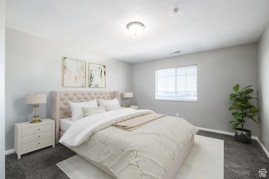 Bedroom featuring a textured ceiling and carpet floors