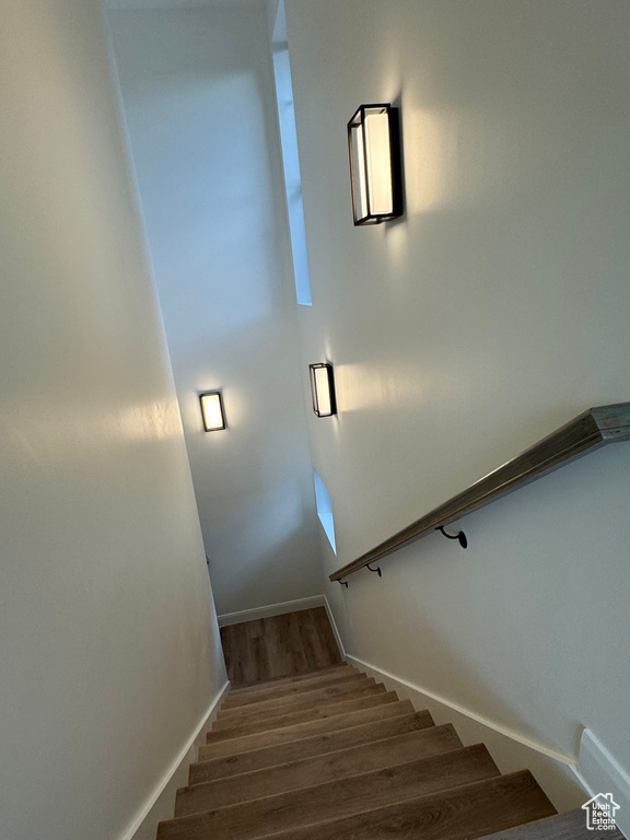 Stairway featuring hardwood / wood-style flooring