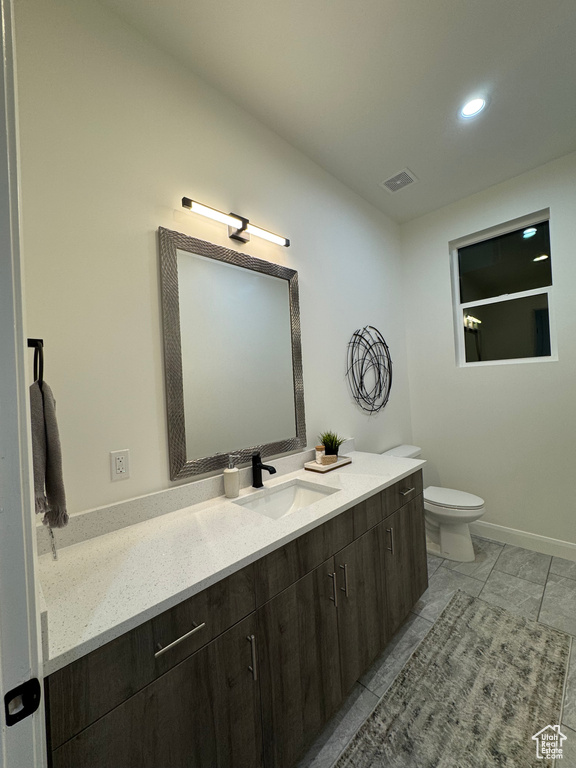 Bathroom featuring vanity and toilet