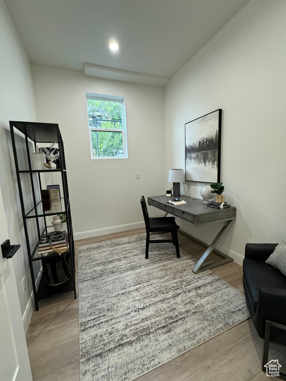 Office with light hardwood / wood-style flooring