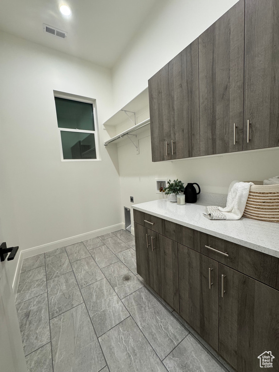 Laundry room featuring cabinets, washer hookup, and hookup for an electric dryer