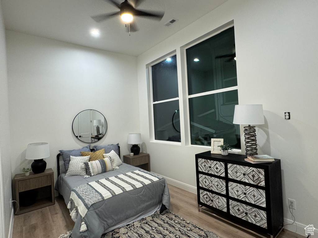 Bedroom with hardwood / wood-style flooring and ceiling fan