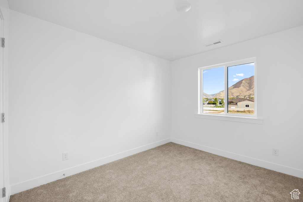 Carpeted spare room with a mountain view