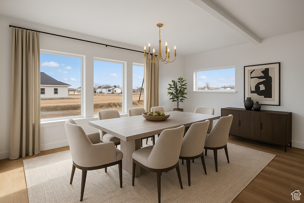 Dining space with baseboards, beamed ceiling, a notable chandelier, and wood finished floors