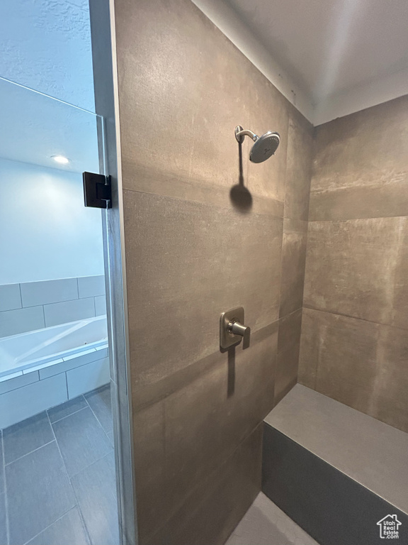 Full bathroom featuring tiled shower, tile patterned floors, and a tub