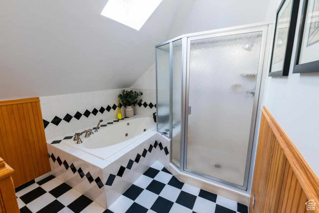 Bathroom with lofted ceiling with skylight and plus walk in shower