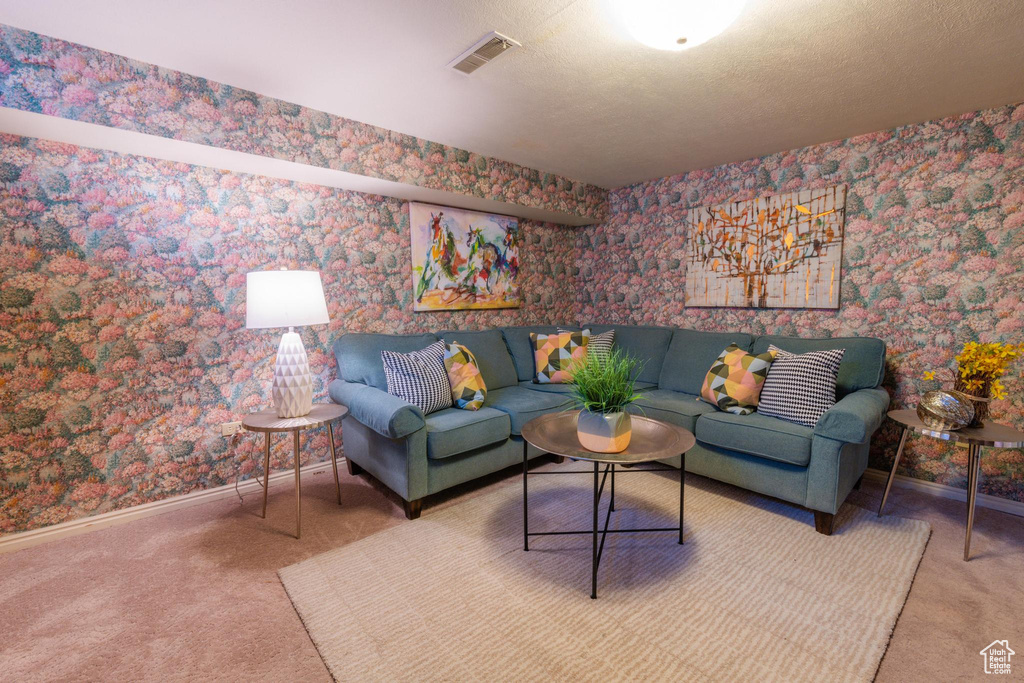 Living room with a textured ceiling and carpet