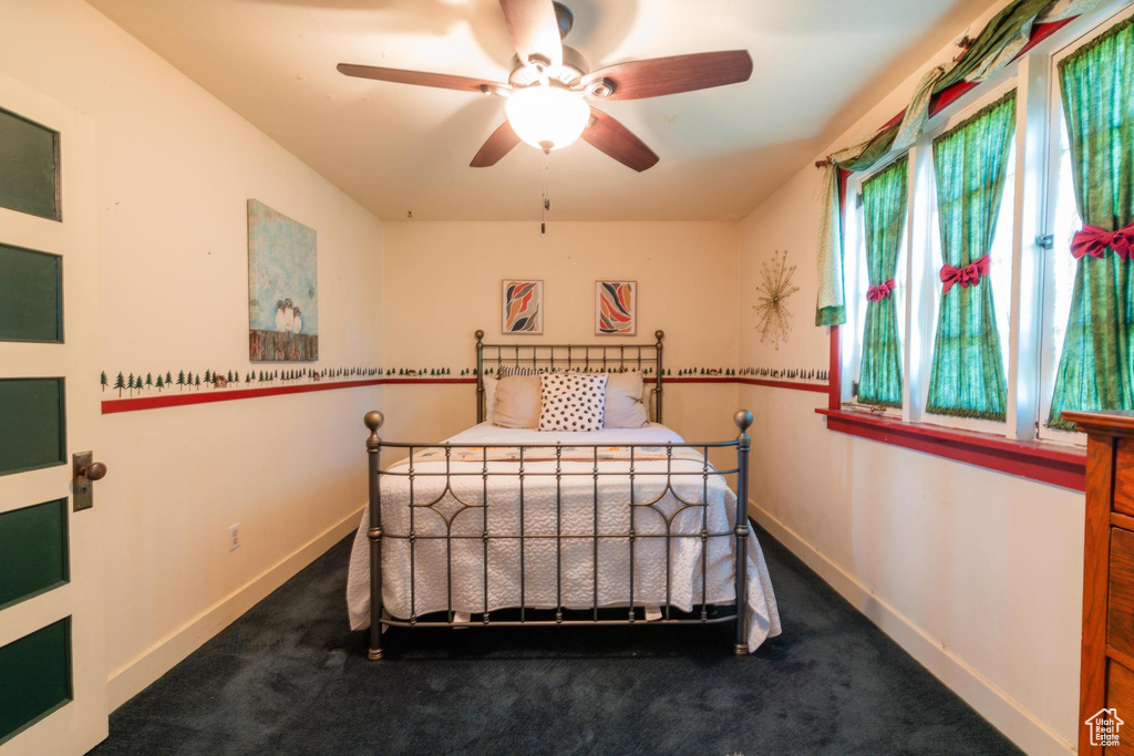 Bedroom with ceiling fan and carpet