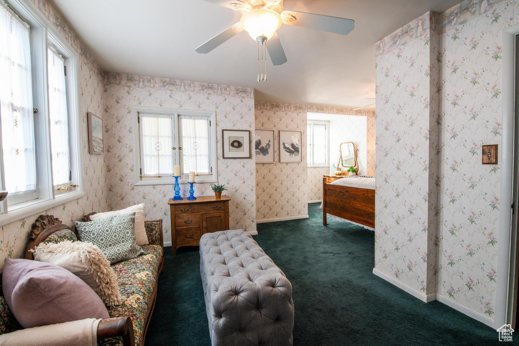 Carpeted bedroom featuring ceiling fan