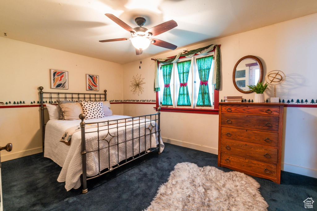 Bedroom featuring dark colored carpet and ceiling fan