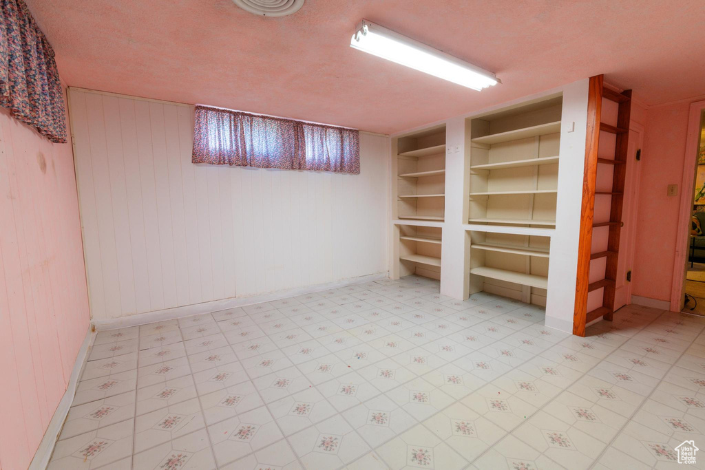 Basement featuring wooden walls