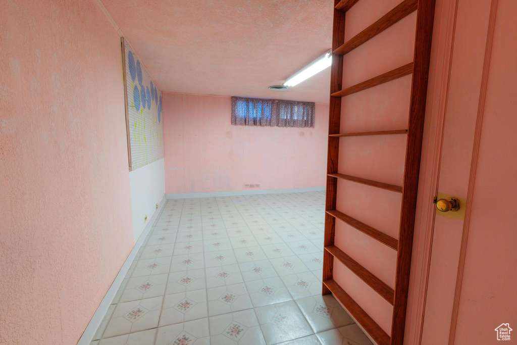 Hall featuring a textured ceiling