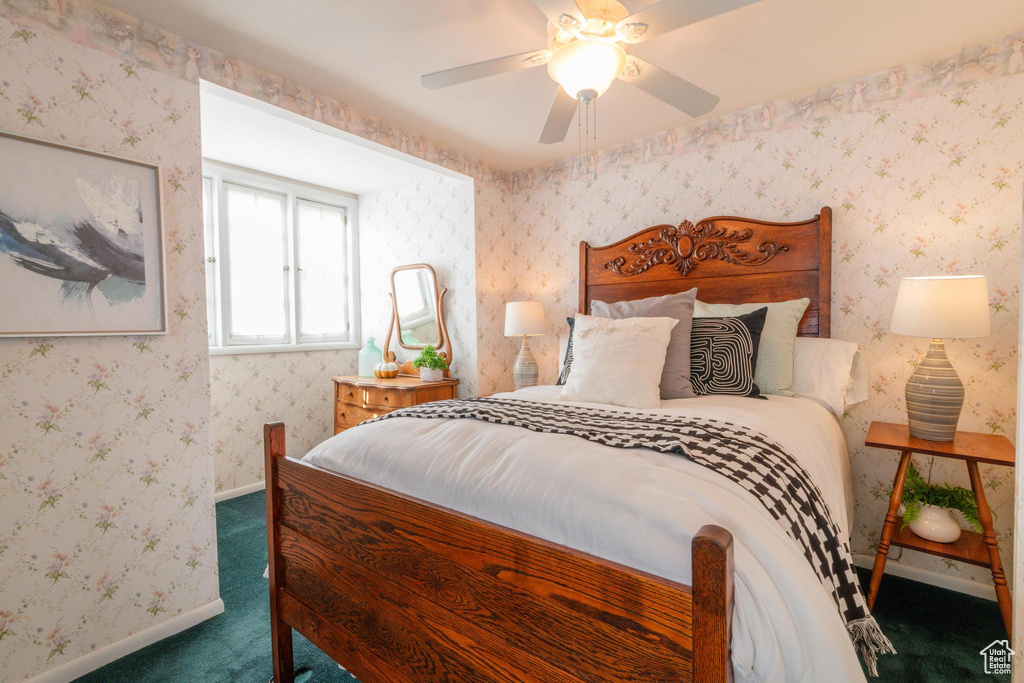 Carpeted bedroom featuring ceiling fan