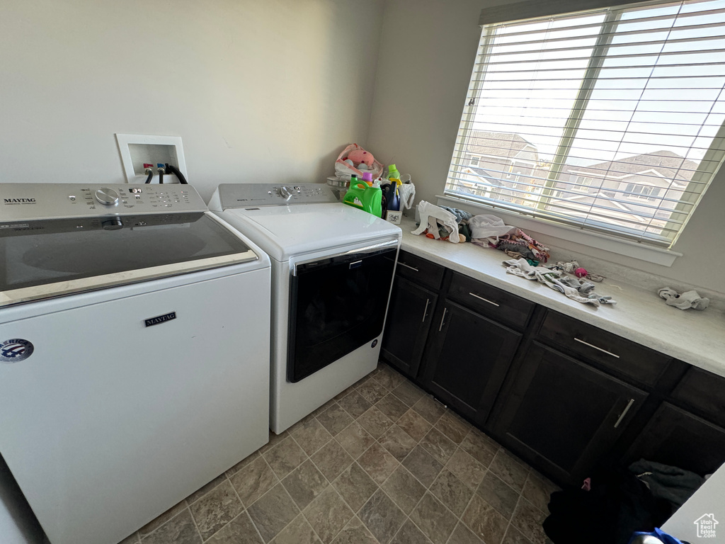 Washroom with cabinets and washing machine and clothes dryer