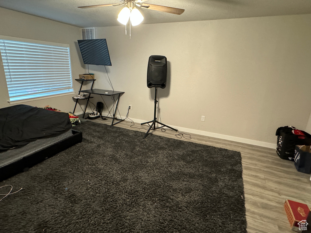 Bedroom featuring wood-type flooring and ceiling fan