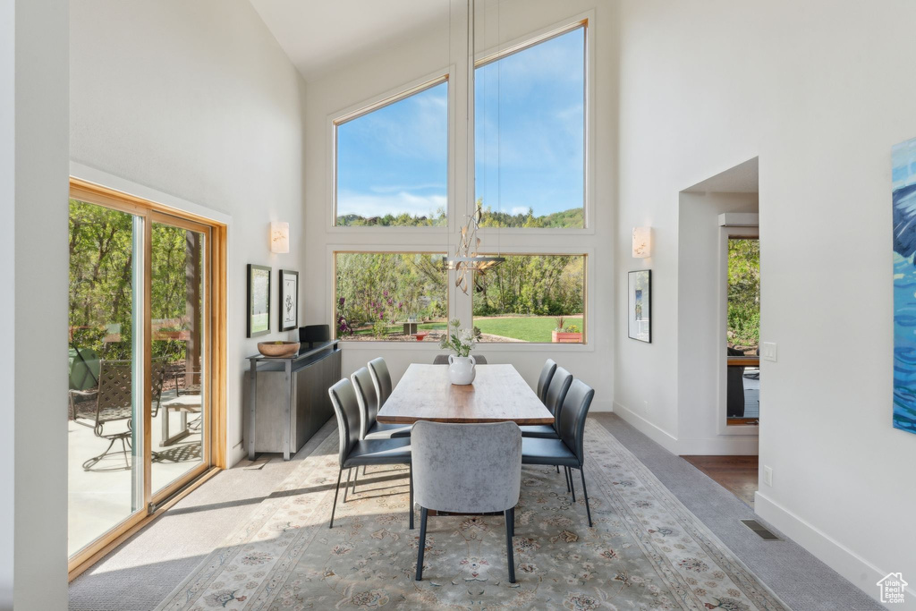 Dining space featuring a high ceiling, healthy amount of natural light, and baseboards