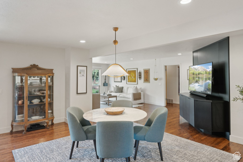 Dining area featuring dark wood finished floors, recessed lighting, and baseboards
