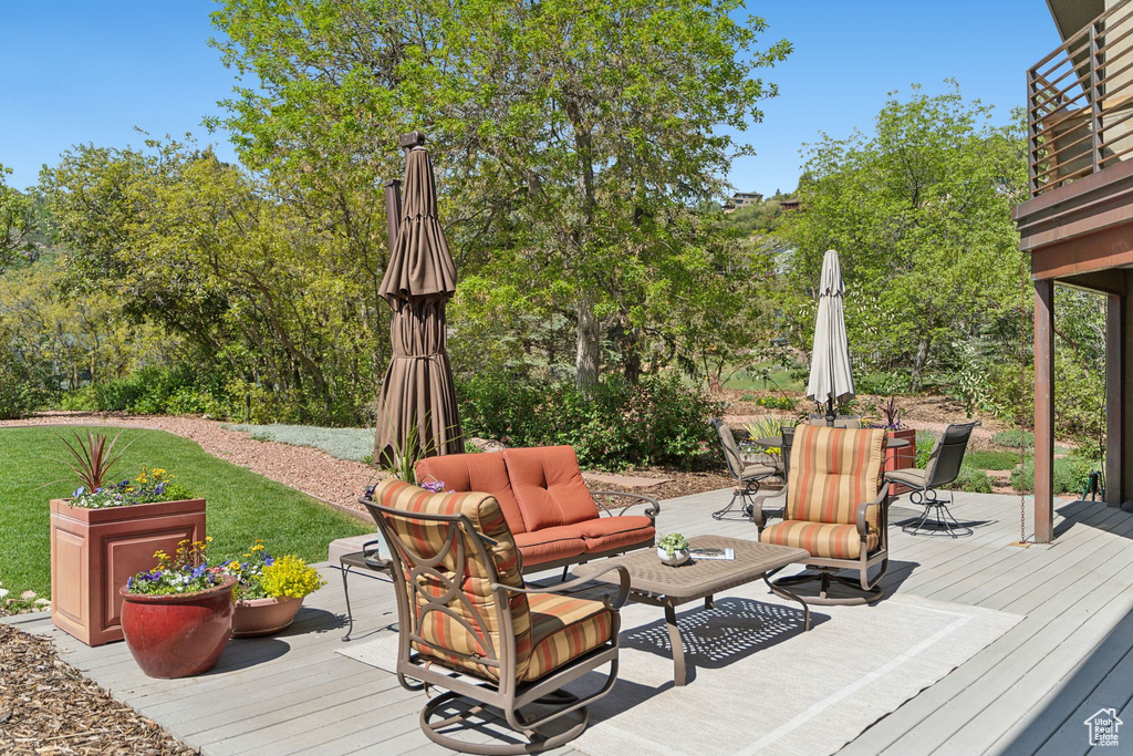 Wooden deck featuring an outdoor hangout area and outdoor dining area