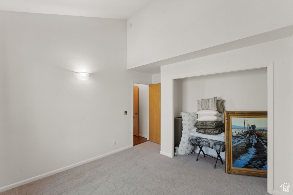 Bedroom featuring carpet and baseboards