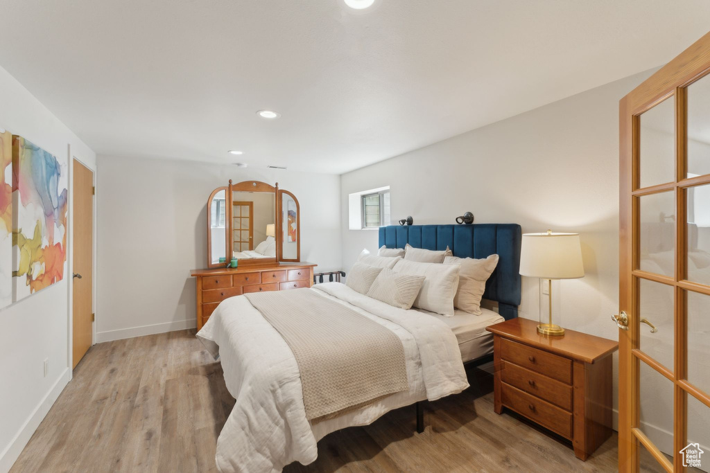 Bedroom featuring wood finished floors, recessed lighting, and baseboards
