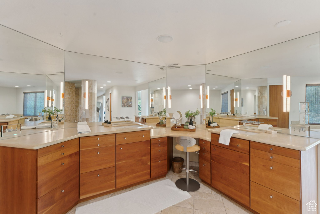 Bathroom with healthy amount of natural light, vanity, and recessed lighting
