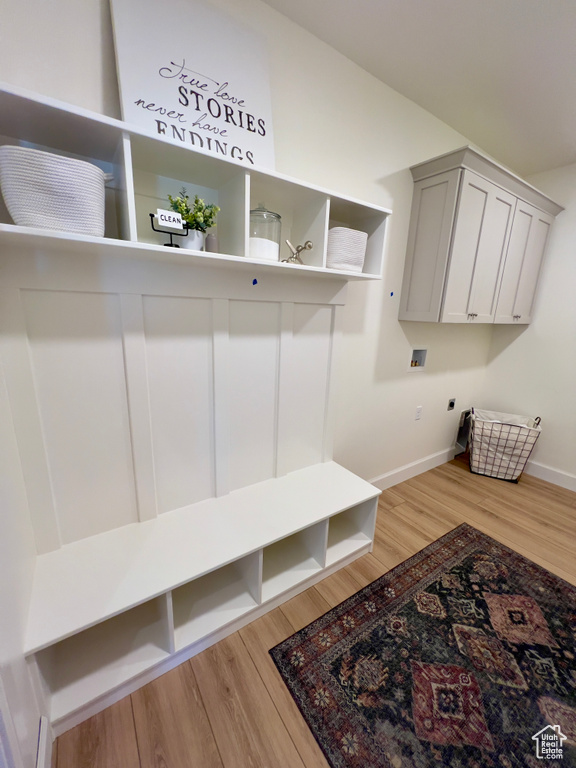 Mudroom with baseboards and light wood-type flooring