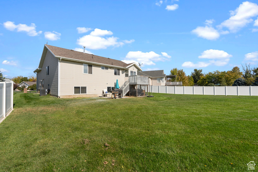 Back of property featuring a yard