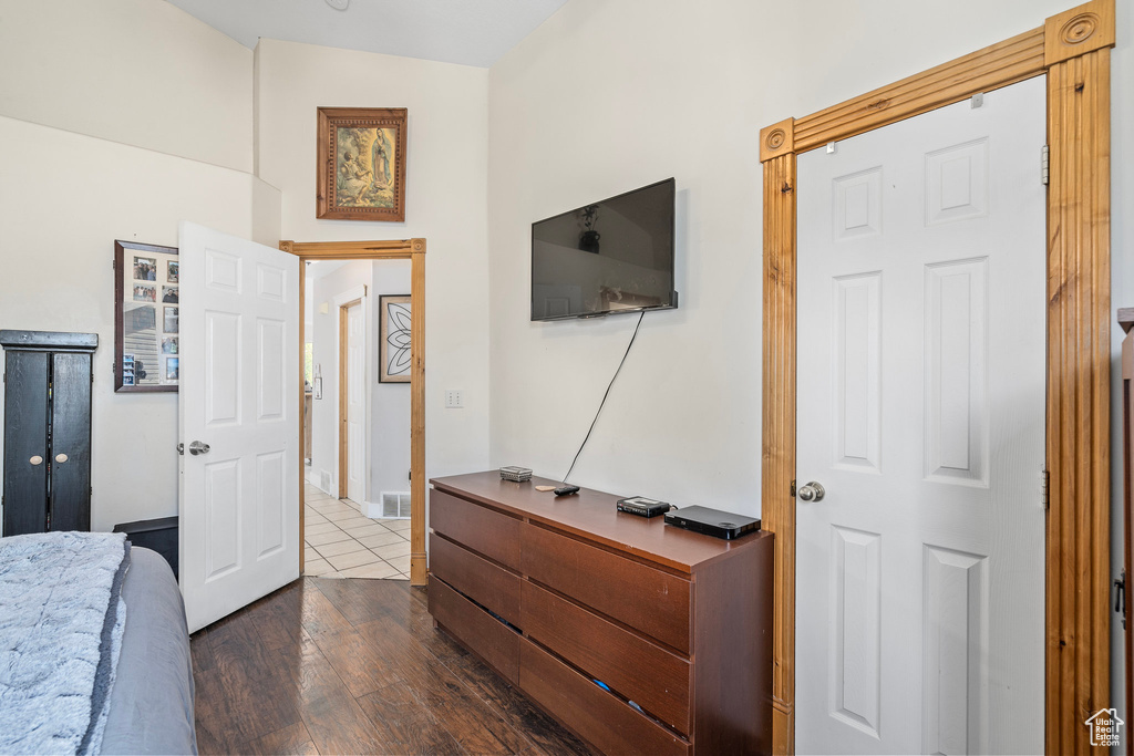 Bedroom with dark hardwood / wood-style flooring