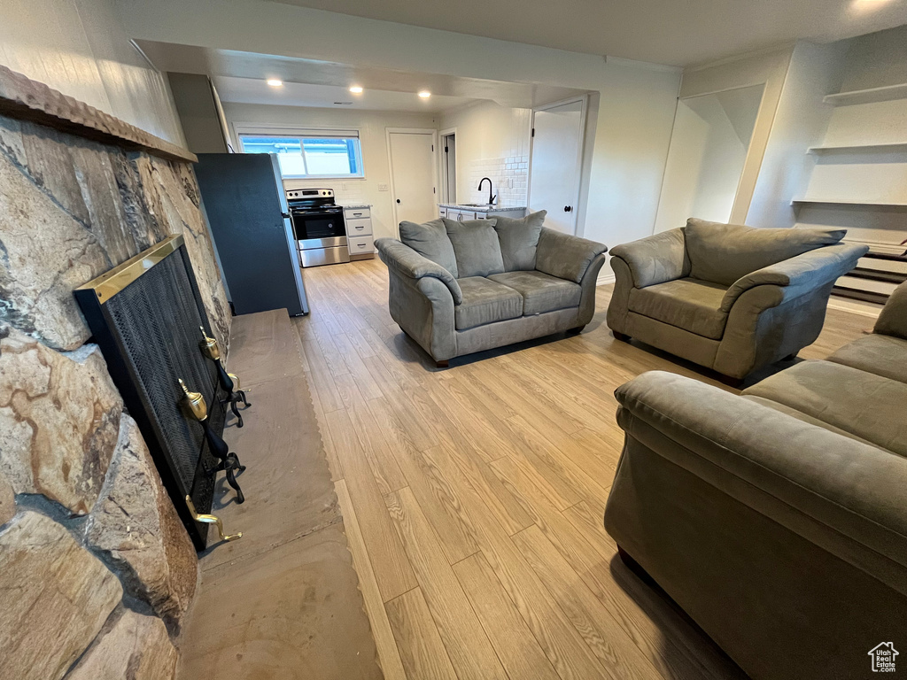 Living room with sink and light wood-type flooring