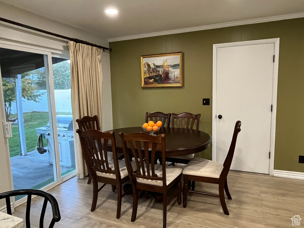 Dining area featuring light hardwood / wood-style floors and crown molding