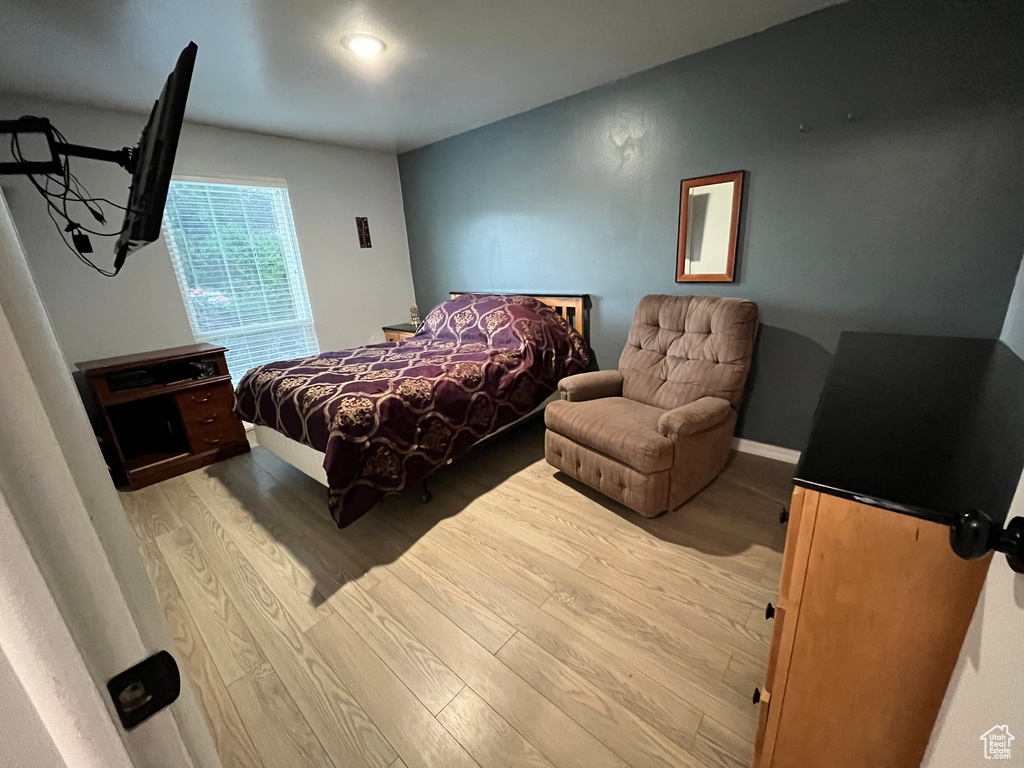 Bedroom with light hardwood / wood-style floors