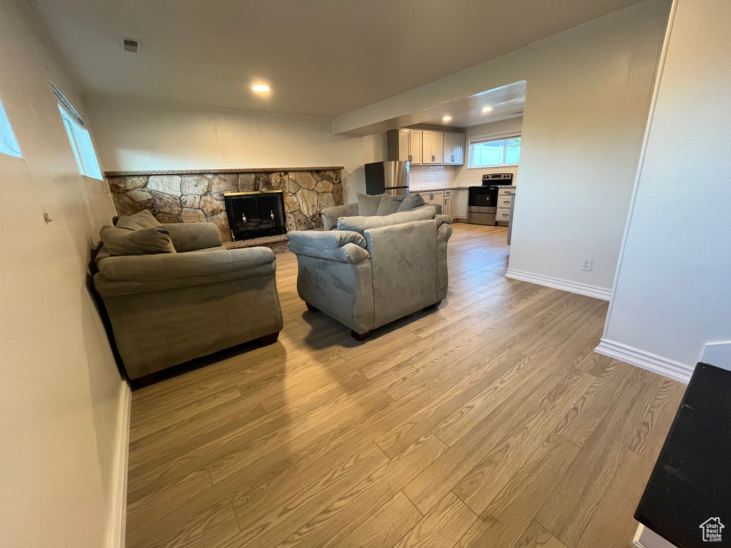 Living room featuring a fireplace and light wood-type flooring