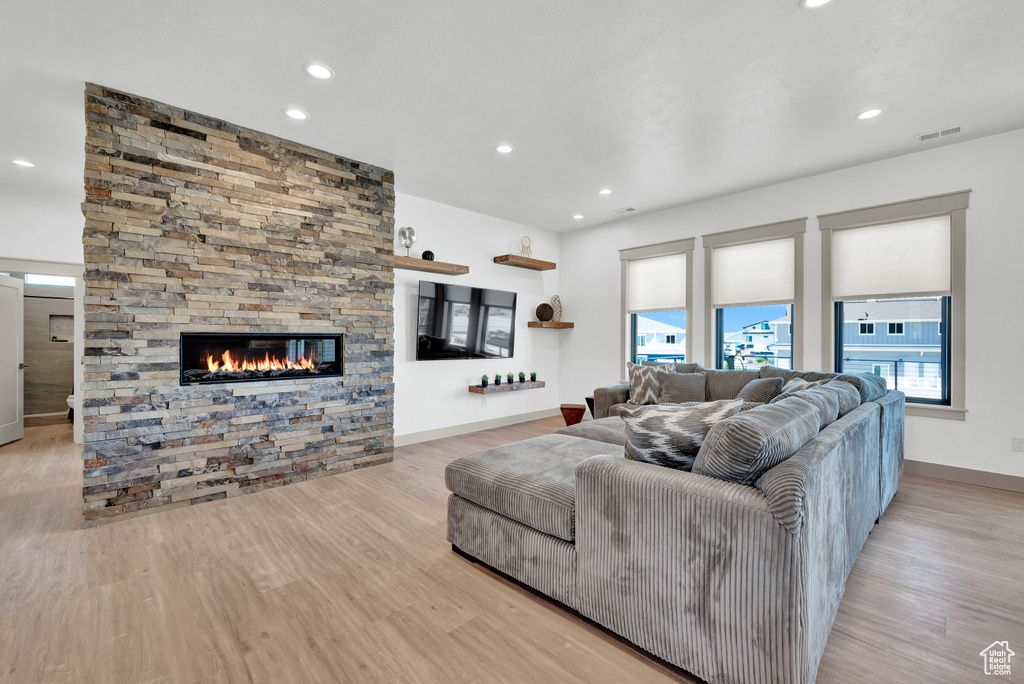 Living room featuring light hardwood / wood-style flooring and a fireplace