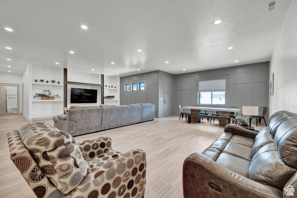 Living room with light hardwood / wood-style floors