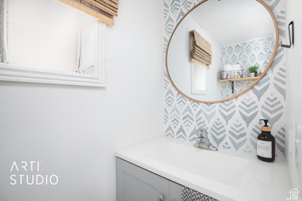 Bathroom with vanity and backsplash