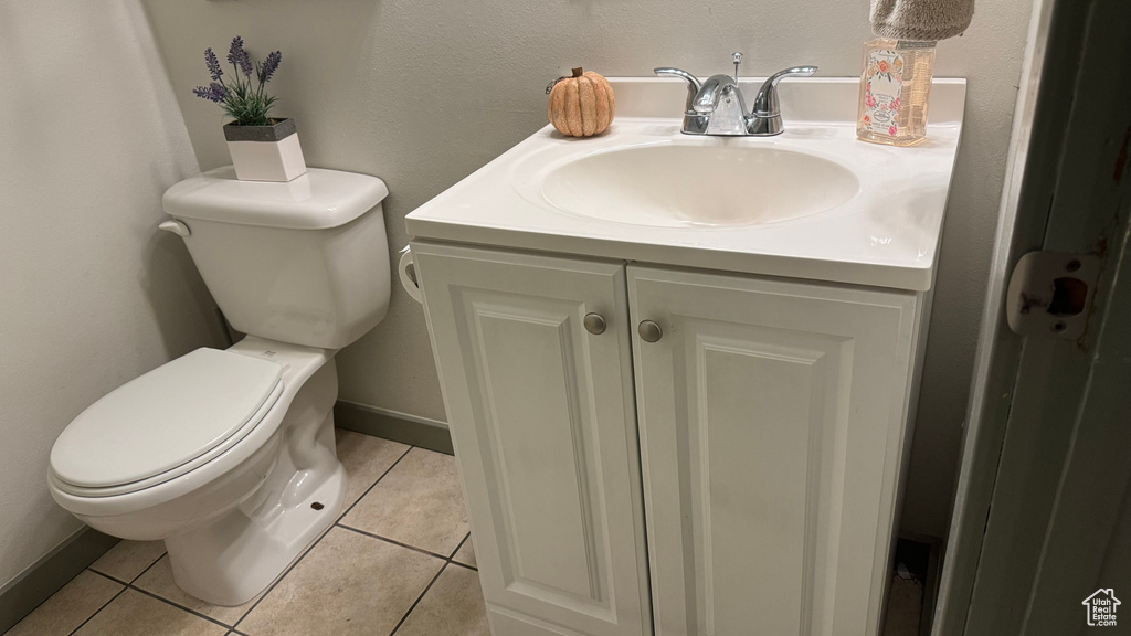 Bathroom with vanity, toilet, and tile patterned floors