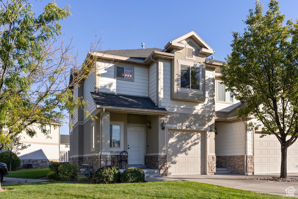 View of front of property with a front lawn and a garage